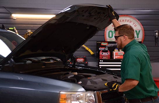 Chris from O’Reilly Auto Parts opening the hood to the 2011 Chevy Silverado 1500